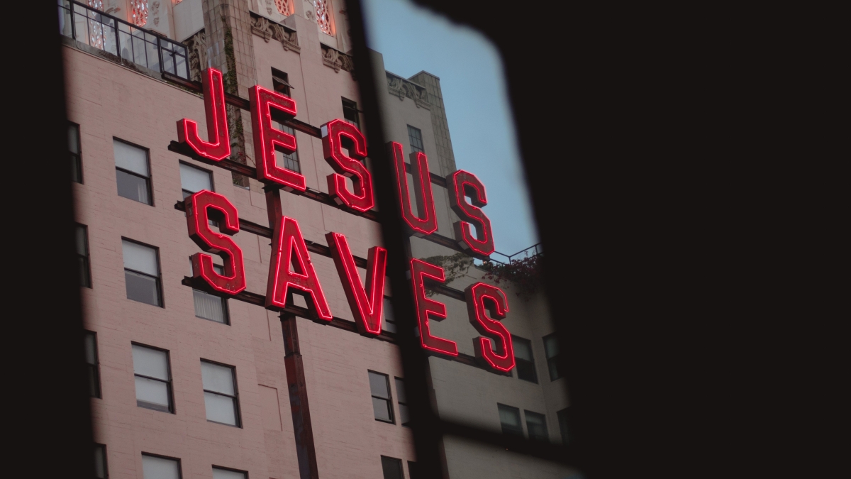 Neon sign on building "Jesus Saves"