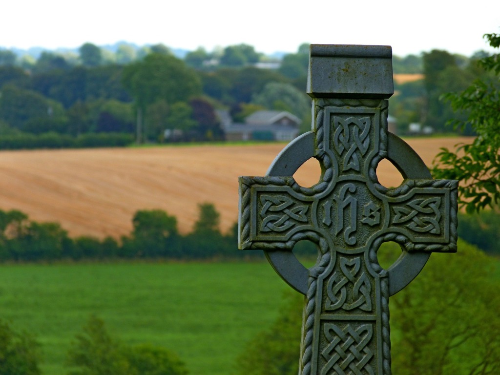 Stone Irish cross in rural landscape